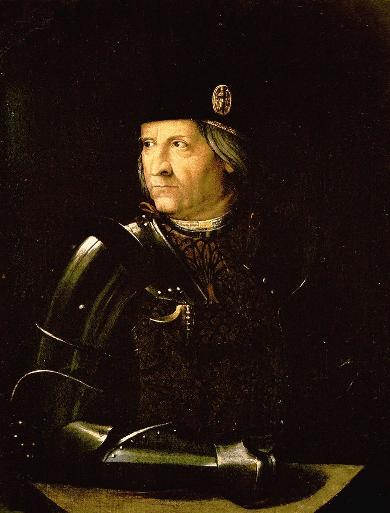 Un homme âgé de trois quarts, en armure sombre et toque noire à médaille d’or, l’avant-bras posé sur un rebord.
